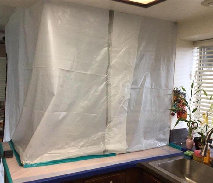 Plastic sheets containing mold-infested area. 