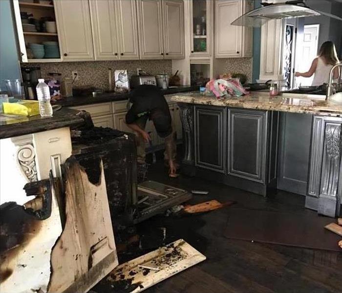 Specialist is cleaning fire damage in a home.