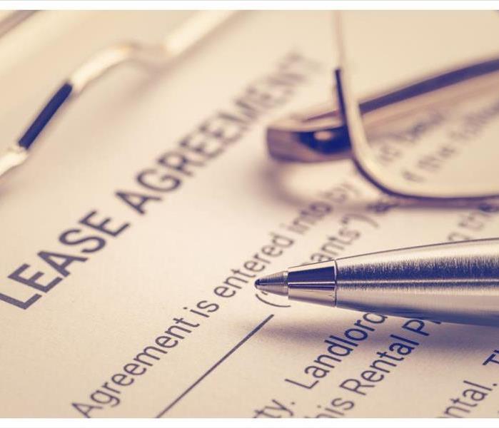 Pen and glasses on a lease agreement form.